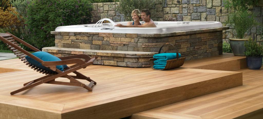 Stealth Hot Tub in a backyard setting with seating and lighting