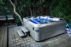 people enjoying Celtic Hot Tub in backyard at night