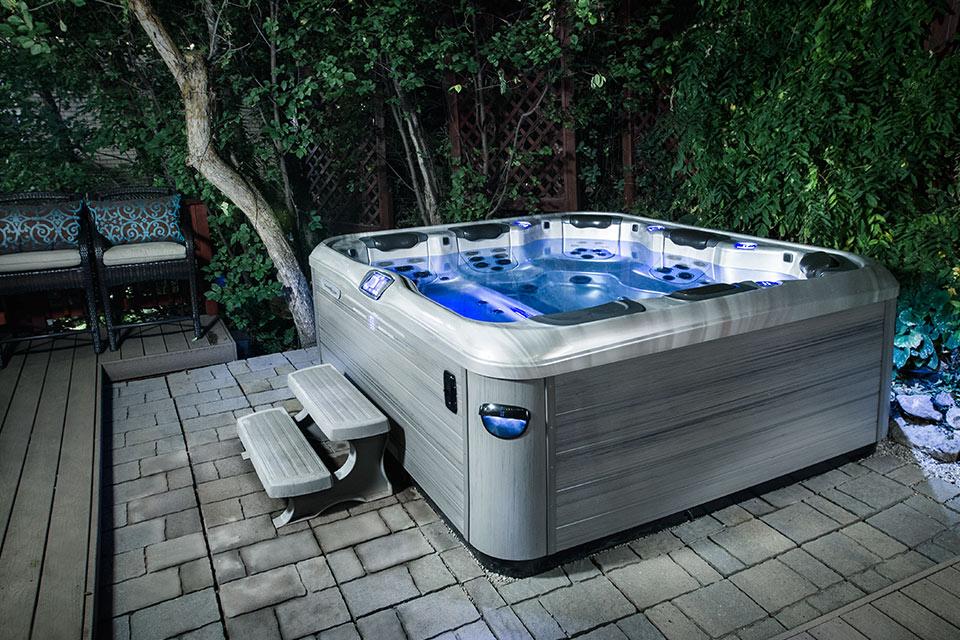 people enjoying Celtic Hot Tub in backyard at night