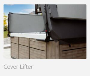 Outdoor kitchen island with a built-in grill; a cover lifter raises the grill cover over wooden cabinets.