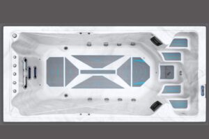 Top-down view of a white rectangular hot tub with blue-accented seating pads and multiple jet nozzles