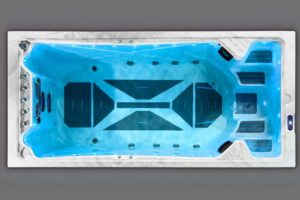 Top-down view of a blue-lit rectangular hot tub with built-in seating and multiple jets.
